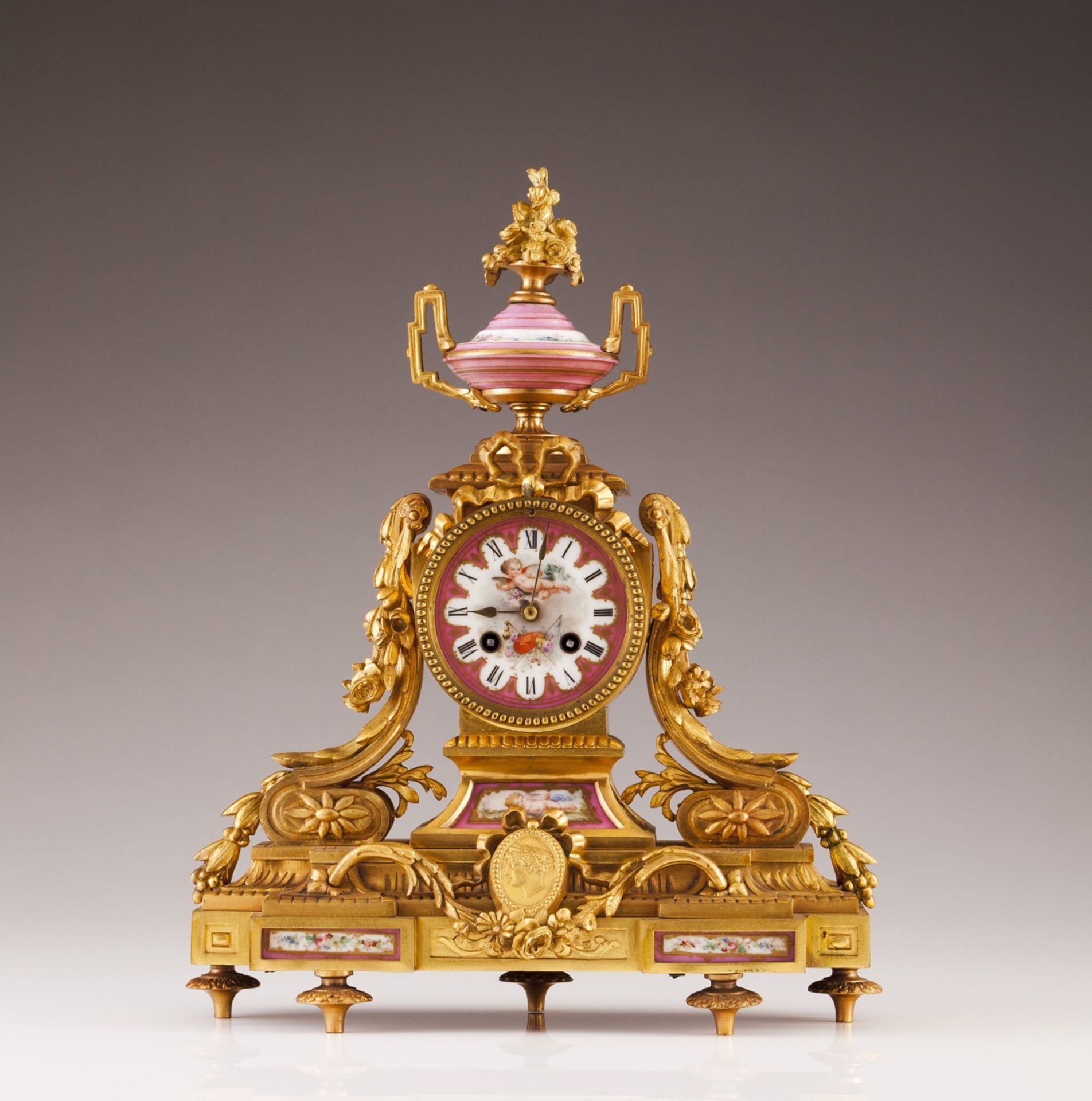 A French late 19th, early 20th century table clock  Gilt bronze d'art  French porcelain plaques