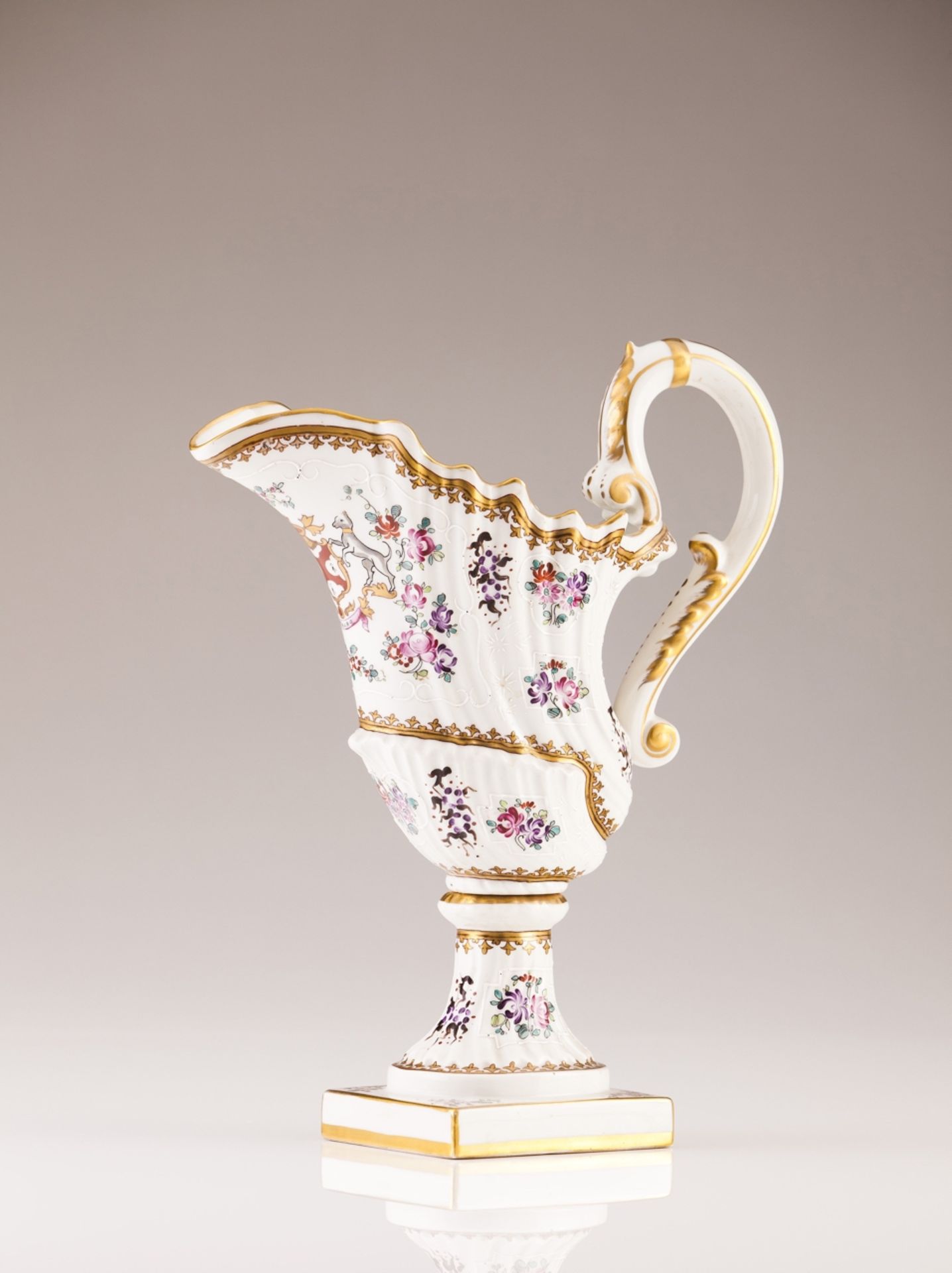 A 19th century Paris porcelain ewer  In the Rocaille manner  Polychrome and gilt decoration with