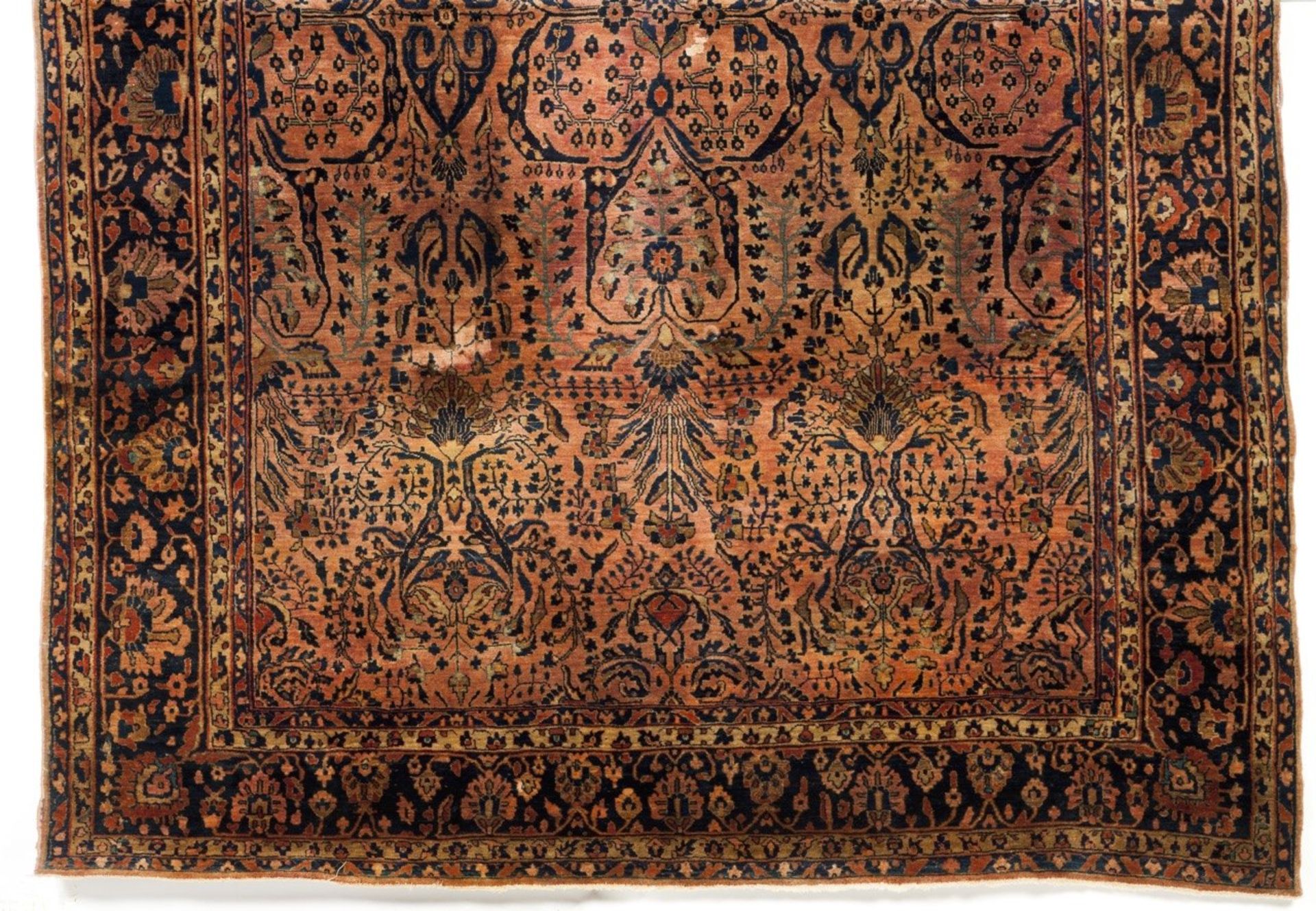 A Persian Sarooq cotton and wool carpet  Of floral and geometric design in coral and blue