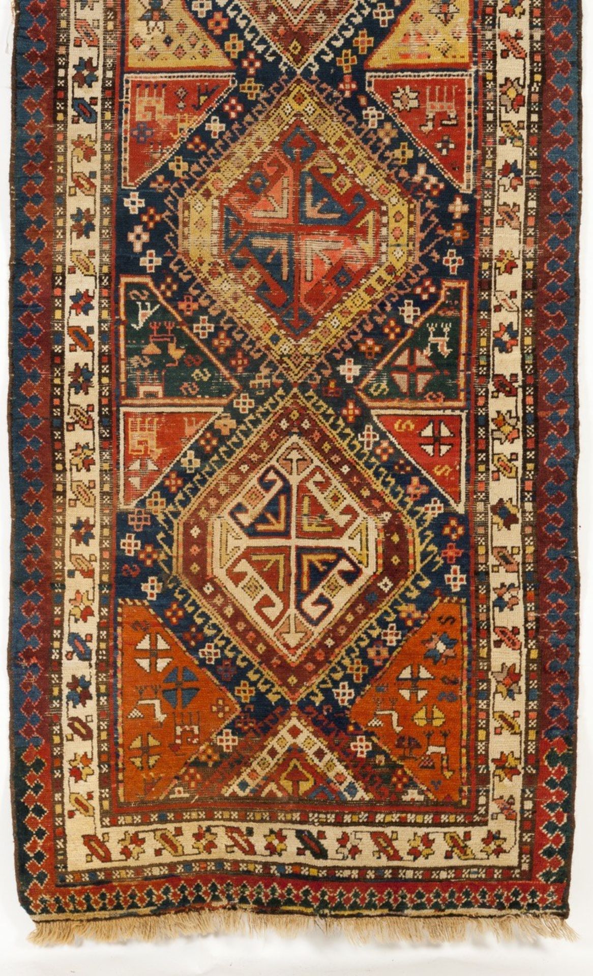 An antique Kazak cotton and wool carpet  Of geometric design in blue, brown and beige    362x106 cm