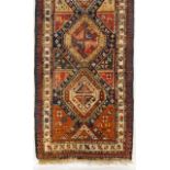 An antique Kazak cotton and wool carpet  Of geometric design in blue, brown and beige    362x106 cm