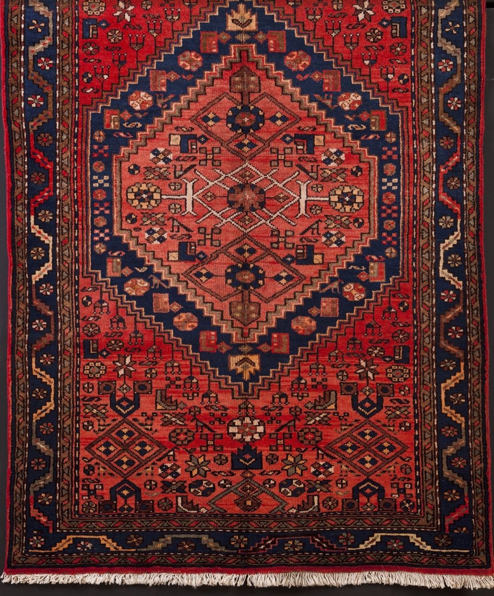 A Zanjan Persian carpet  Cotton and wool  Geometric decoration in blue, red and brown    225x135 cm