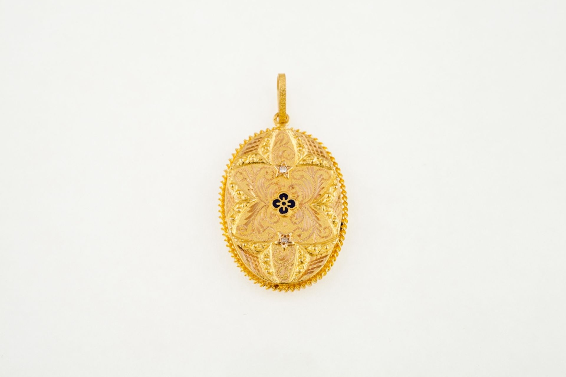 A Portuguese gold pendant/reliquary  Relief, chiseled and enameled 19kt gold, set with two small