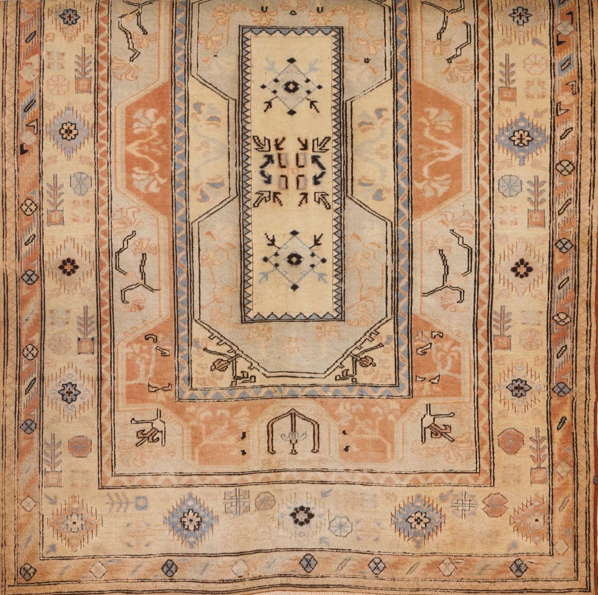 A Persian Sarooq cotton and wool carpet  Of floral and geometric design in blue, beige and coral