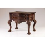 A chestnut small side table  In the D.José style  Decorated with carvings  Scalloped aprons, ball