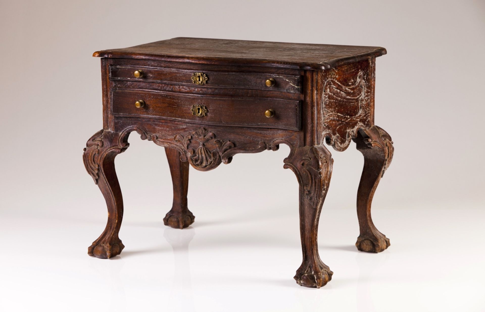 A chestnut small side table  In the D.José style  Decorated with carvings  Scalloped aprons, ball