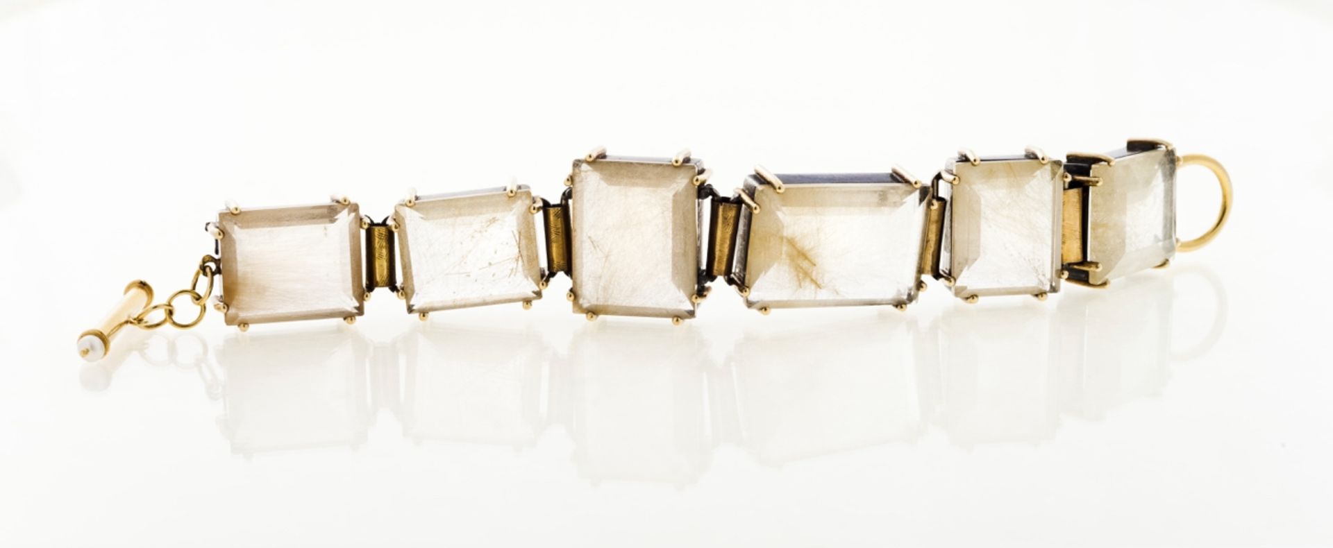 A rutilated quartz bracelet  Set in silver and gold with two cultured pearls  Portugal, 20th