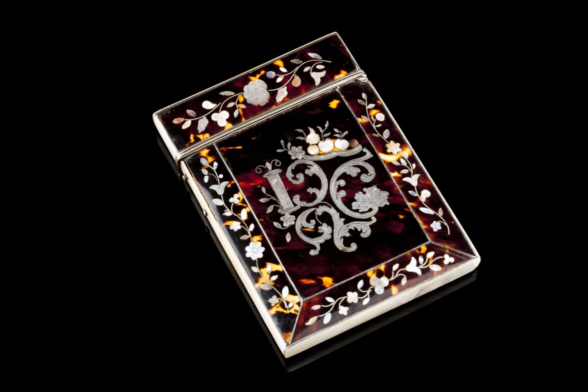 A Tortoiseshell, mother-of-pearl and silver cardbox
Decorated with floral motifs and cathedral
(