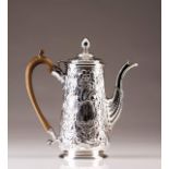 A George III silver coffee pot
Profuse relief decoration with flowers, volutes, scaled surfaces,