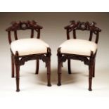 A pair of chairs
Mahogany
Carved "marriage" decoration 
Pierced backs and rails with doves and