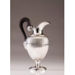 A Neoclassical Belgian silver jug
Fluted decoration, wood handle with chiseled finials, the lower