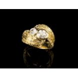 A diamond ring
Set in textured gold with two old brilliant cut diamonds weighing approx. 1,00ct