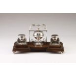 A silver-mounted desk-set
Late 19th, early 20th century
Wood base with silver mounts and feet in the