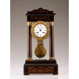 A 19th century French table clock
Mahogany veneered wood with marquetry decoration and brass