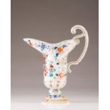 An ewer
Chinese export porcelain
Of mannerist design, circular base and scroll handle
Polychrome and