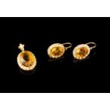 A demi-parure
Comprising a pair of earrings and a pendant
Gold set with half-pearls, one citrine (