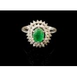 A diamond and emerald ring
Set in white gold with one oval cut emerald and 42 single cut diamonds
(
