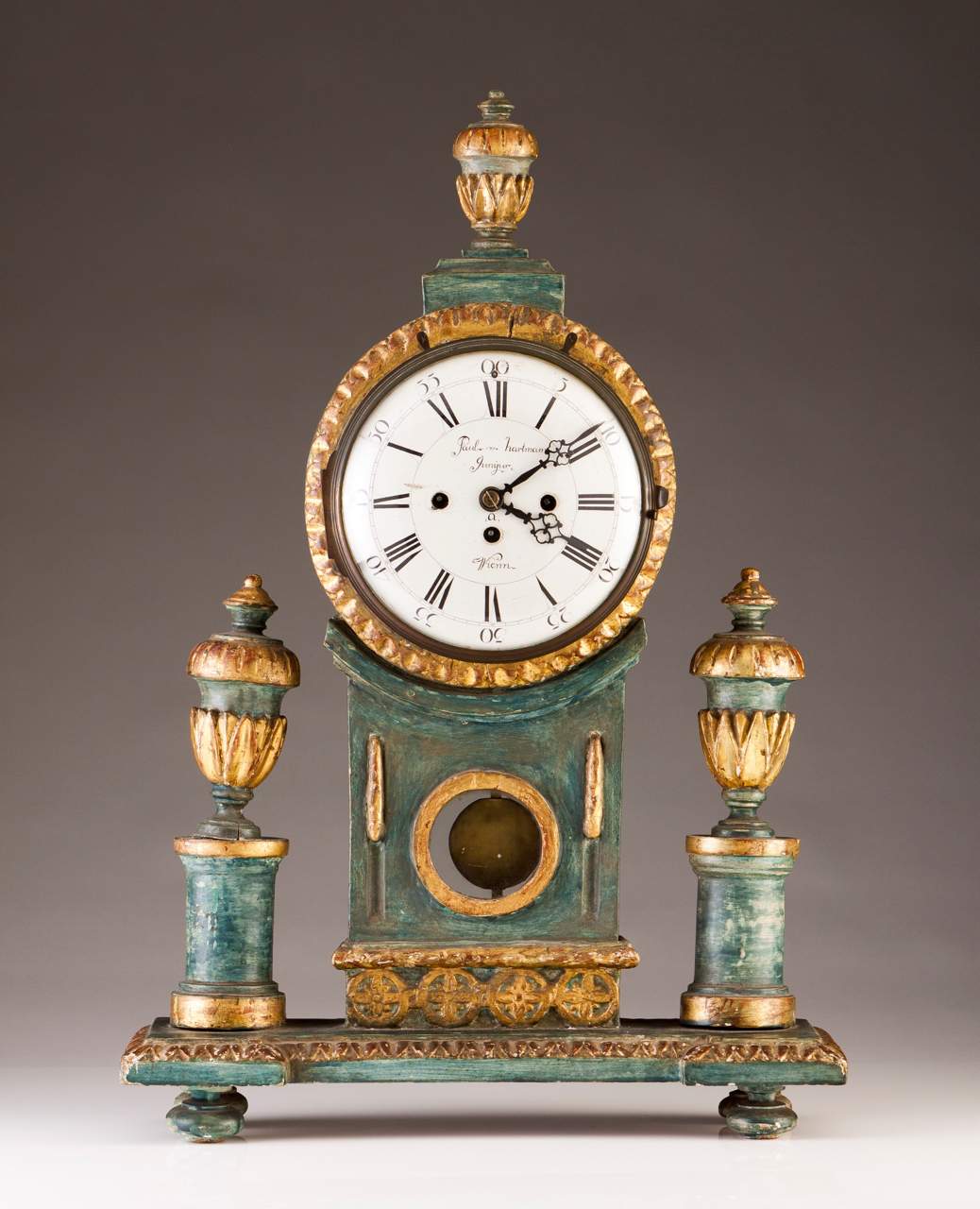 A table clock
Painted and gilt carved wood case
Winding mechanism, marked Paul Hartmann Junior