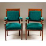 A pair of Empire style armchairs
Mahogany
Decorated with yellow metal mounts representing feminine