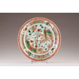A plate
Chinese porcelain
Polychrome Famille Verte decoration depicting exotic birds, flowers and