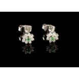 A pair of gem-set earrings
White gold set with small single cut diamonds and two round emeralds