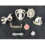 Five white metal brooches and two St. Ch