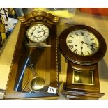 Two vintage style wooden wall hanging clocks.