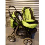 Green and Black Baby-Merc pram with matching car seat and carry cot.