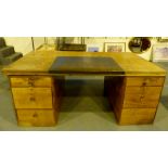 Light oak twin pedestal desk with blue leather insert,