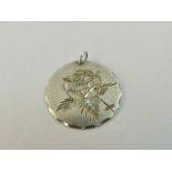 Sterling silver circular pendent with engraved flower