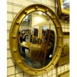 Convex mirror oval in shape with gold frame