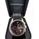 Emporio Armani chronograph wristwatch with multi-dial black face with a rose gold surround on a