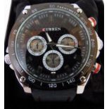 Black faced multi-dial/function Curren wristwatch with rubber strap.