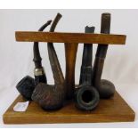 Antique pipe rack with pipes and unusual pipe tool