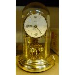 Brass mechanical anniversary clock with glass dome