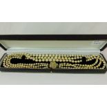 Three stranded graduated pearl necklace with silver clasp in presentation case