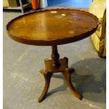 Walnut occasional table with central pillar and four fluted leg supports