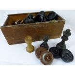 Box of carved wood chess and draught pieces