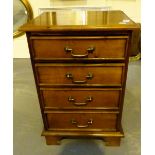 Small modern hardwood chest of four drawers.