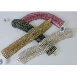 Four white metal and jeweled bracelets