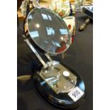 Large silver magnifying glass on a wooden base