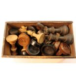 Box of carved wood chess and draught pieces