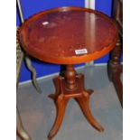 Walnut occasional table with central pillar and four fluted leg supports
