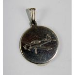 Sterling silver circular pendant with engraving of a plane