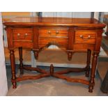Mahogany desk with three drawers and carved wooden stretchers,
