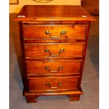 Small modern hardwood chest of four drawers.