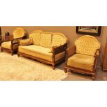 Bergere three piece suite with decorative carving to base and arms,