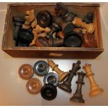 Box of carved wood chess and draught pieces