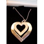 White metal necklace with a white metal pendant in the shape of two hearts