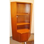 Teak corner two shelved bookcase with cupboard.